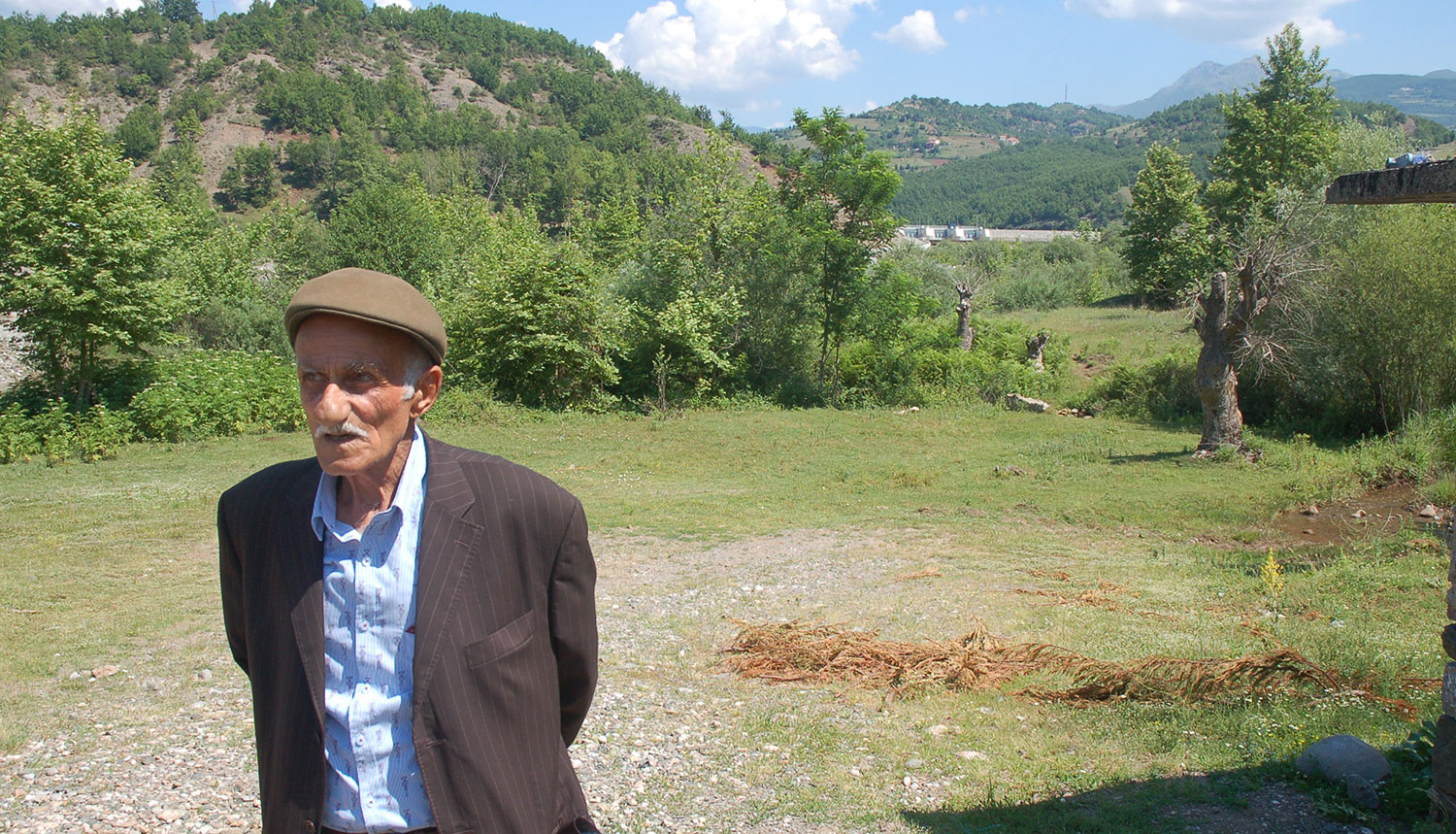 Xhevahir cannot use his water mill anymore. (The Rapuni dam can be seen in the background.) © Bankwatch
